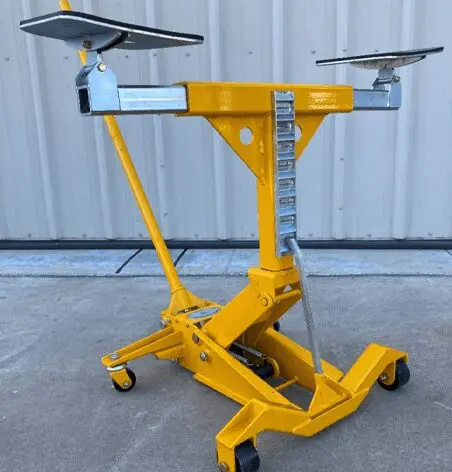 A yellow dolly with two solar panels on it.