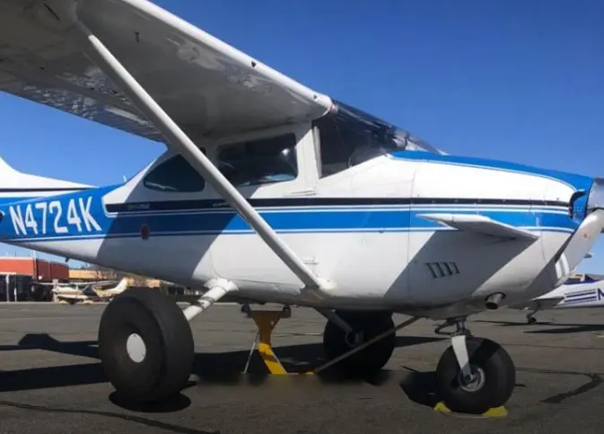 An Aircraft With White Body And Blue Stripes